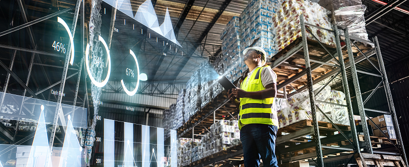 Warehouse employee reviewing supply chain data with augmented reality interface